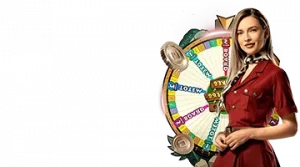 Image featuring a female host standing next to a spinning game wheel, promoting the Snakes and Ladders live game at Gizbo Casino.